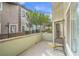 An outdoor patio featuring a view of neighboring buildings and greenery at 10431 Kitty Joyce Ave, Las Vegas, NV 89129