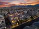 An elevated neighborhood view, revealing a beautiful sunset, city lights and mountain views at 10725 Wrigley Field Ave, Las Vegas, NV 89166