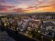 A neighborhood aerial view, showcasing beautiful homes and a stunning sunset backdrop at 10725 Wrigley Field Ave, Las Vegas, NV 89166