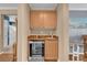 Stylish bar area with wine fridge, granite countertop, cabinets, and sink, perfect for entertaining at 10725 Wrigley Field Ave, Las Vegas, NV 89166