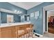 Bathroom with double sink vanity, framed mirror, decor and blue accent wall at 10725 Wrigley Field Ave, Las Vegas, NV 89166