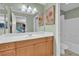 Bright bathroom with a large mirror, wooden cabinets, and a shower-tub combination at 10725 Wrigley Field Ave, Las Vegas, NV 89166