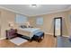 Bright bedroom featuring a queen size bed, dark wood furnishings, neutral walls, and an oversized mirror at 10725 Wrigley Field Ave, Las Vegas, NV 89166