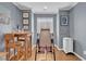 Bedroom featuring light gray walls, hardwood floors, an exercise machine, and natural light at 10725 Wrigley Field Ave, Las Vegas, NV 89166