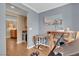 Bedroom featuring light gray walls, hardwood floors, an exercise machine, and ensuite bathroom access at 10725 Wrigley Field Ave, Las Vegas, NV 89166