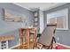 Bedroom featuring light gray walls, hardwood floors, an exercise machine, and natural light at 10725 Wrigley Field Ave, Las Vegas, NV 89166