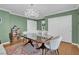 Stylish dining room with a modern chandelier, neutral decor, and ample storage at 10725 Wrigley Field Ave, Las Vegas, NV 89166