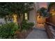 Inviting home exterior features manicured landscaping, stone walkway, warm lighting and neutral color palette at 10725 Wrigley Field Ave, Las Vegas, NV 89166