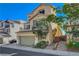 Charming stucco home featuring a two-car garage, balcony, and well-maintained landscaping at 10725 Wrigley Field Ave, Las Vegas, NV 89166