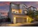 Two-story home boasting a balcony, desert landscaping, and an attached two-car garage at 10725 Wrigley Field Ave, Las Vegas, NV 89166