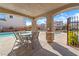 Community pool area with covered seating, stone columns, and clear blue water at 10725 Wrigley Field Ave, Las Vegas, NV 89166