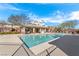 Inviting community pool area with plenty of room for relaxation, featuring an open layout and lush trees at 10725 Wrigley Field Ave, Las Vegas, NV 89166