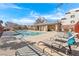 Community pool with lounge chairs, a covered area, and clear blue water for relaxation at 10725 Wrigley Field Ave, Las Vegas, NV 89166