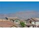 Overhead shot of residential rooftops with mountain views on a bright sunny day at 10725 Wrigley Field Ave, Las Vegas, NV 89166