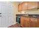 Convenient wet bar area featuring granite countertops, cabinetry, and a beverage refrigerator at 10725 Wrigley Field Ave, Las Vegas, NV 89166