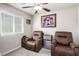 Bedroom featuring two recliners, decor and a ceiling fan at 10922 Cambridge Lakes Ave, Las Vegas, NV 89166