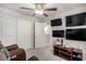 Bedroom featuring a ceiling fan, 3 TVs, and decor at 10922 Cambridge Lakes Ave, Las Vegas, NV 89166