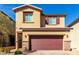 Front exterior of a two-story home with a two-car garage and well-maintained landscaping at 10922 Cambridge Lakes Ave, Las Vegas, NV 89166