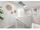 Bright upstairs hallway featuring carpeted floors, white walls and decorative wall art at 10922 Cambridge Lakes Ave, Las Vegas, NV 89166