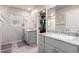 Main bathroom featuring double sinks, granite countertops, and a walk-in closet at 10922 Cambridge Lakes Ave, Las Vegas, NV 89166