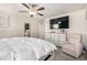 Spacious Primary bedroom featuring ceiling fan, large dresser, and neutral walls at 10922 Cambridge Lakes Ave, Las Vegas, NV 89166