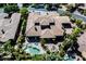 Aerial view of a luxurious home featuring a large swimming pool, lush landscaping, and a well-maintained property at 11 Belfair Ct, Henderson, NV 89052