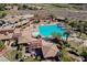 Aerial view of the community pool area with palm trees, lounge chairs, and a well-maintained pool at 11 Belfair Ct, Henderson, NV 89052