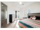 Bright bedroom with ceiling fan, glass door to balcony, and striped blanket on bed at 11 Belfair Ct, Henderson, NV 89052