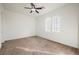 A bright room, with neutral carpet, features two windows, and a ceiling fan at 11 Belfair Ct, Henderson, NV 89052