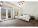 Light-filled bedroom with french doors to the backyard, and a calm, neutral color palette at 11 Belfair Ct, Henderson, NV 89052