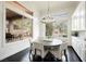 Bright breakfast nook with backyard views, elegant light fixture, and built in cabinetry at 11 Belfair Ct, Henderson, NV 89052