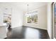 Bright dining room features dark wood floors and a large window overlooking the backyard at 11 Belfair Ct, Henderson, NV 89052