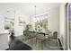 Bright dining room featuring a modern chandelier, large windows with views, and stylish decor at 11 Belfair Ct, Henderson, NV 89052