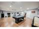 Open game room featuring pool table, shuffle board, and stairs to second floor at 11 Belfair Ct, Henderson, NV 89052