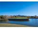 Scenic view of a golf course island green surrounded by water, creating a challenging and beautiful landscape at 11 Belfair Ct, Henderson, NV 89052