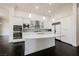 Bright kitchen featuring a large island with marble countertops, stainless steel appliances and white cabinetry at 11 Belfair Ct, Henderson, NV 89052