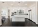 Open-concept kitchen featuring modern white cabinets, marble island, and stainless steel appliances at 11 Belfair Ct, Henderson, NV 89052