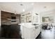 Open floor plan featuring the kitchen island and a living room with a wooden accent wall at 11 Belfair Ct, Henderson, NV 89052