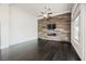 Empty living room with hardwood floors, fireplace and a wood accent wall at 11 Belfair Ct, Henderson, NV 89052