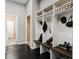 This mudroom features custom built-in shelving, a bench, and dark wood flooring at 11 Belfair Ct, Henderson, NV 89052