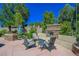 Outdoor patio area featuring comfortable seating, a stone fireplace, and a serene space for gatherings and relaxation at 11 Belfair Ct, Henderson, NV 89052