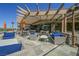 This stylish outdoor patio offers comfortable seating and a shaded pergola for relaxing and entertaining at 11 Belfair Ct, Henderson, NV 89052