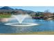 A serene pond with a fountain set against the backdrop of mountains and lush landscaping creates a tranquil atmosphere at 11 Belfair Ct, Henderson, NV 89052