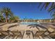 Beautiful community pool area with lounge chairs and palm trees, perfect for relaxation at 11 Belfair Ct, Henderson, NV 89052