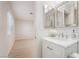 Bright bathroom with a marble vanity, chrome fixtures and window view of the bedroom at 1105 Pawnee Ln, Henderson, NV 89015