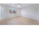 Neutral bedroom featuring wood-look floors, a ceiling fan and a sunlit window at 1105 Pawnee Ln, Henderson, NV 89015