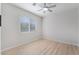 This bright bedroom features wood-look floors, a ceiling fan, and a window at 1105 Pawnee Ln, Henderson, NV 89015