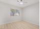 This bright bedroom features wood-look floors, a ceiling fan, and a window at 1105 Pawnee Ln, Henderson, NV 89015