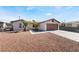 Charming single-story home with desert landscaping, paved driveway, and attached two-car garage at 1105 Pawnee Ln, Henderson, NV 89015