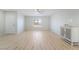 Sunlit living room showcasing wood-look floors, an entry door and a large window at 1105 Pawnee Ln, Henderson, NV 89015